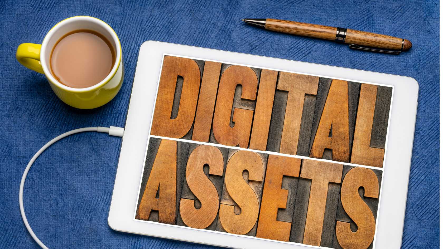 Cup of coffee and electronic device with the word Digital Assets for an estate planning blog